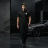man-walking-wearing-black-polo-t-shirt-with-embroidered-logo-premium-casual-style